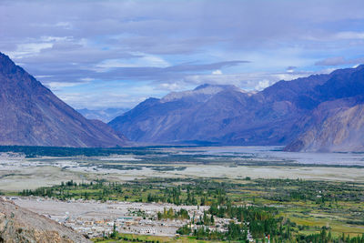 Scenic view of mountains against cloudy sky