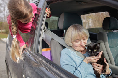 A family driving by car together with their pet. rules of border crossing with animals. travel