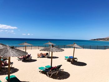 Scenic view of beach against blue sky