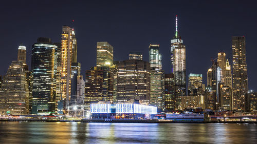 Illuminated buildings against sky at night