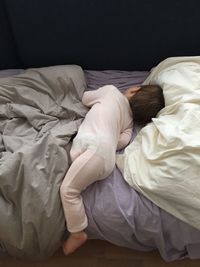 High angle view of boy sleeping on bed at home