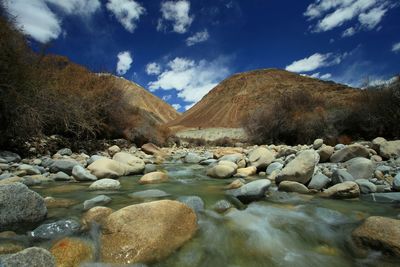 Scenic view of river against cloudy sky