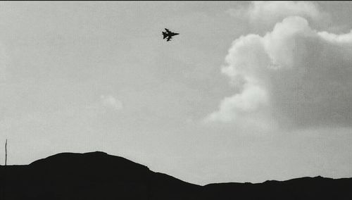 Low angle view of airplane flying in sky