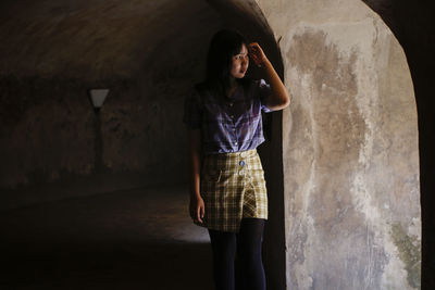 Woman standing against wall