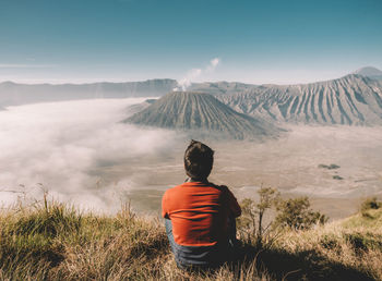 Rear view of man looking at mountains