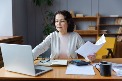 Young woman using laptop at office