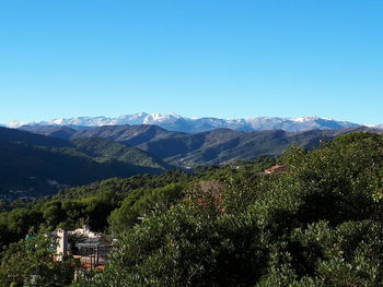 Scenic view of mountains against clear blue sky