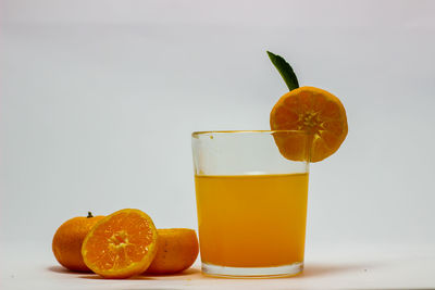 Orange fruit and drink on table
