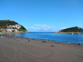 Scenic view of beach against blue sky