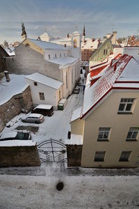 Houses in city against sky during winter
