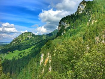 Scenic view of green mountains against sky