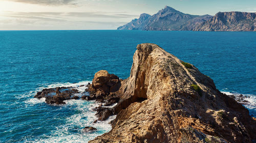 Scenic view of sea against rocky coastline