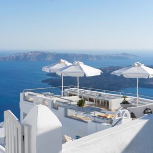 High angle view of parasols with furniture on terrace against sea