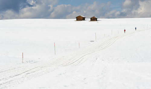 Snow covered field against sky