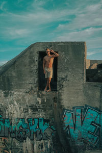 Woman standing against graffiti wall