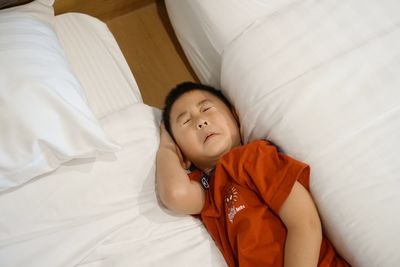 High angle view of baby sleeping on bed