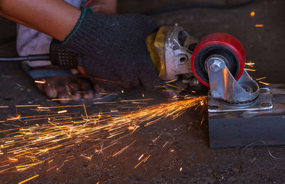 Low angle view of person working on metal