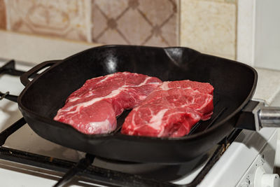 Close-up of meat in cooking pan