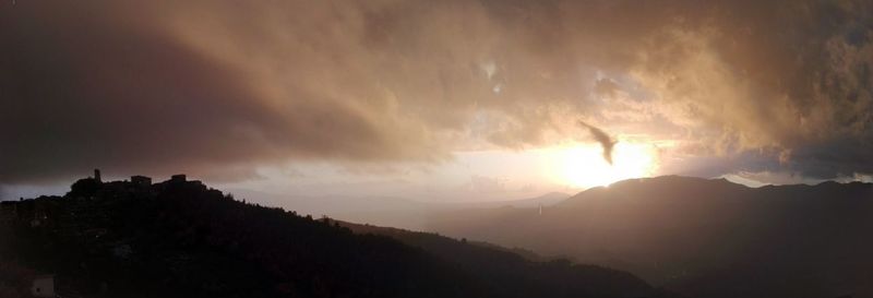 Panoramic view of silhouette mountain against sky during sunset