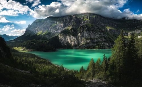 Scenic view of lake and mountains against sky