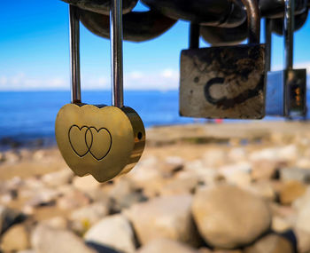 Close-up of love padlocks hanging on heart shape