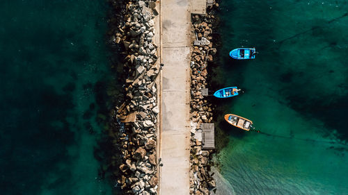 Aerial view of the breakwater in the sea and small boats. beautiful abstract natural background.