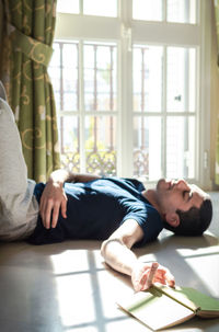 Man lying on floor at home