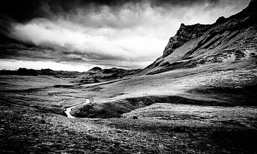 Scenic view of mountains against cloudy sky