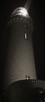 Low angle view of illuminated lamp in building