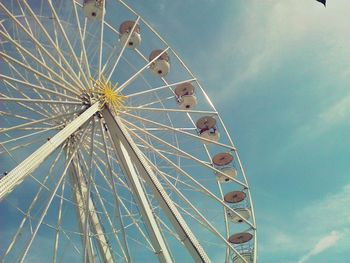 Low angle view of ferris wheel against blue sky