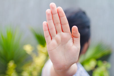 Woman gesturing stop sign outdoors