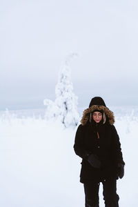 Young woman standing on snow