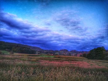 Scenic view of field against sky at dusk