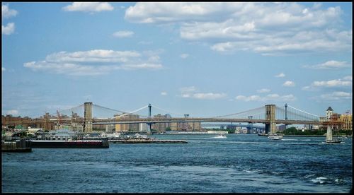 Bridge over river with city in background