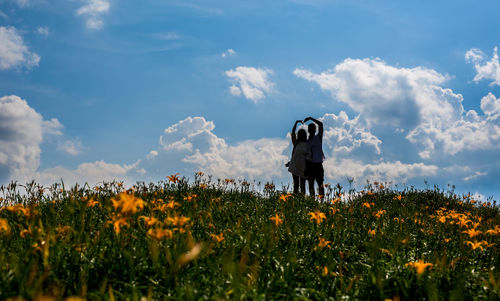 Man standing on field against sky