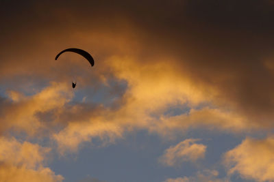 Silhouette of a paraglider at sunset.