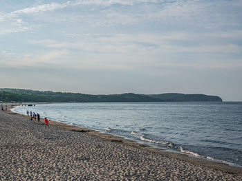 People on beach against sky