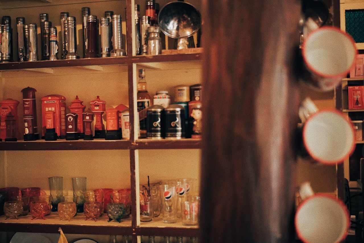 CLOSE-UP OF BOTTLES ON SHELF IN BAR