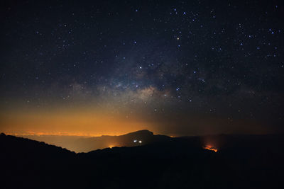 Scenic view of silhouette mountain against sky at night