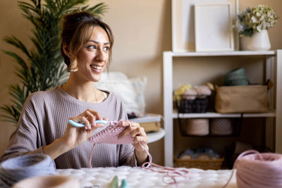 Portrait of young woman sitting at home