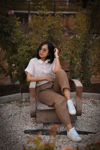 Portrait of a smiling young woman sitting outdoors