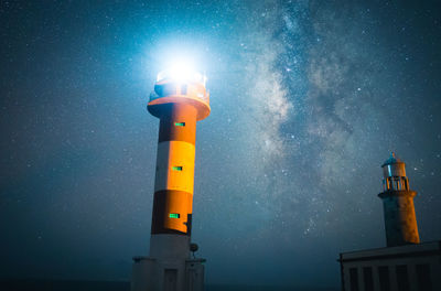 Low angle view of lighthouse against sky at night