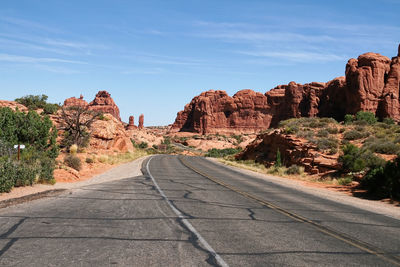 Road amidst rock formation against sky