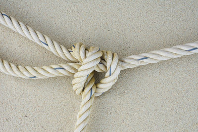 Close-up of tied rope against wall