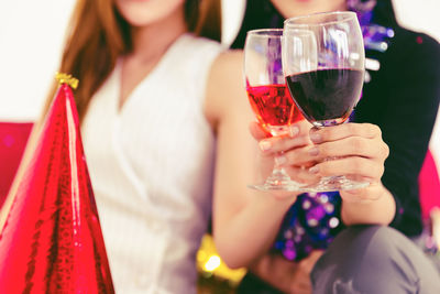 Midsection of woman holding beer glass