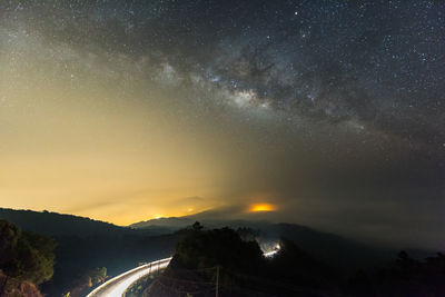 Scenic view of mountains against sky at night