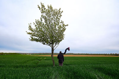 Man standing on field against sky