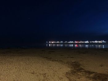 Scenic view of beach against sky at night