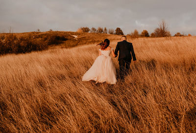 Rear view of woman standing on field