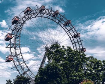 Low angle view of ferris wheel against sky